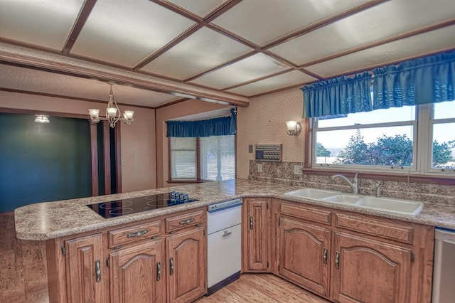 kitchen featuring dishwasher, sink, an inviting chandelier, kitchen peninsula, and black electric stovetop