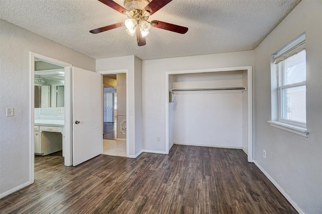 unfurnished bedroom featuring a textured ceiling, ceiling fan, and dark wood-type flooring