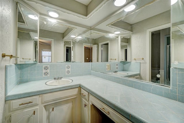 bathroom featuring decorative backsplash and vanity