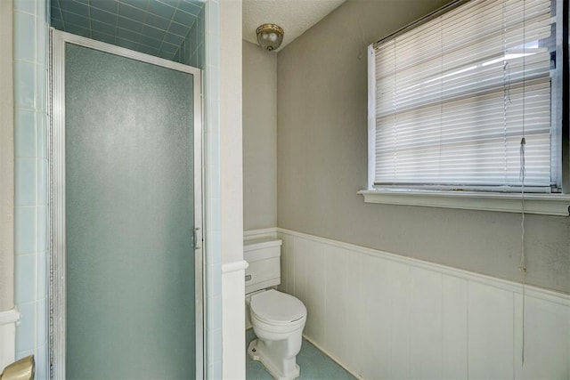 bathroom with toilet and walk in shower