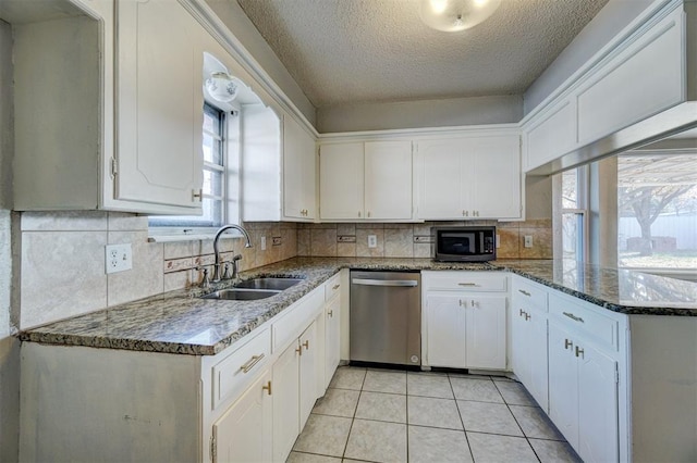 kitchen with white cabinetry, sink, a textured ceiling, light tile patterned floors, and appliances with stainless steel finishes