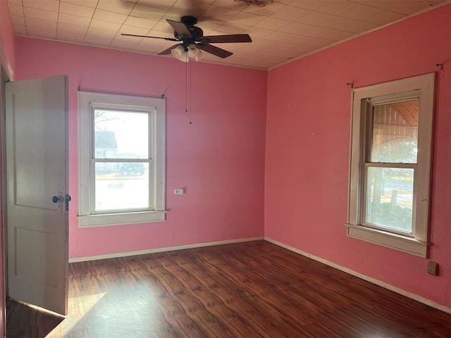 empty room featuring ceiling fan and dark hardwood / wood-style flooring