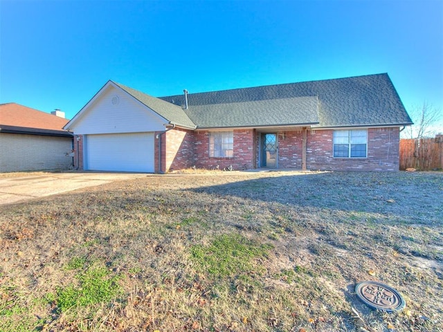 ranch-style home with a front yard and a garage