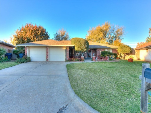 single story home featuring a garage and a front lawn