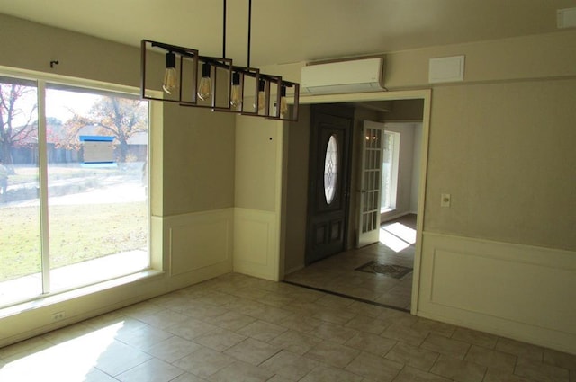 entryway with tile patterned flooring and a wall unit AC