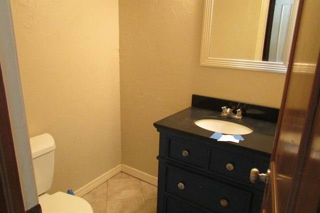 bathroom featuring tile patterned floors, vanity, and toilet