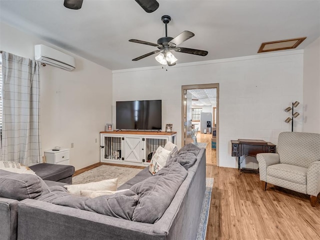 living room with ceiling fan, light wood-type flooring, crown molding, and a wall mounted AC