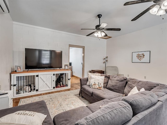 living room featuring a wall mounted air conditioner and light wood-type flooring