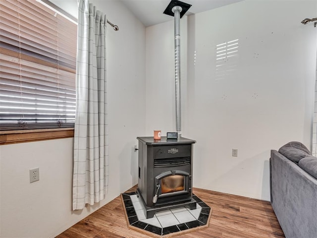 details with hardwood / wood-style floors and a wood stove