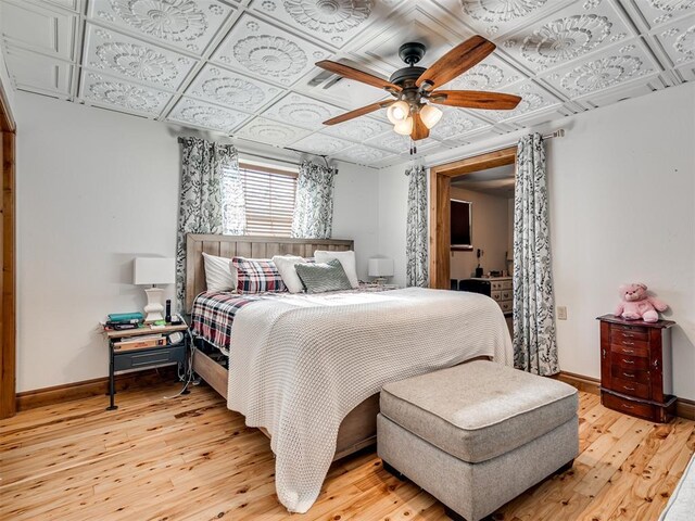 bedroom with hardwood / wood-style floors and ceiling fan