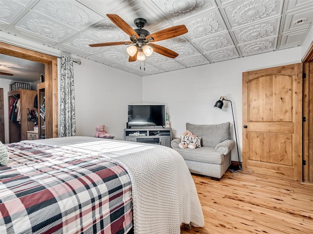 bedroom featuring wood-type flooring and ceiling fan