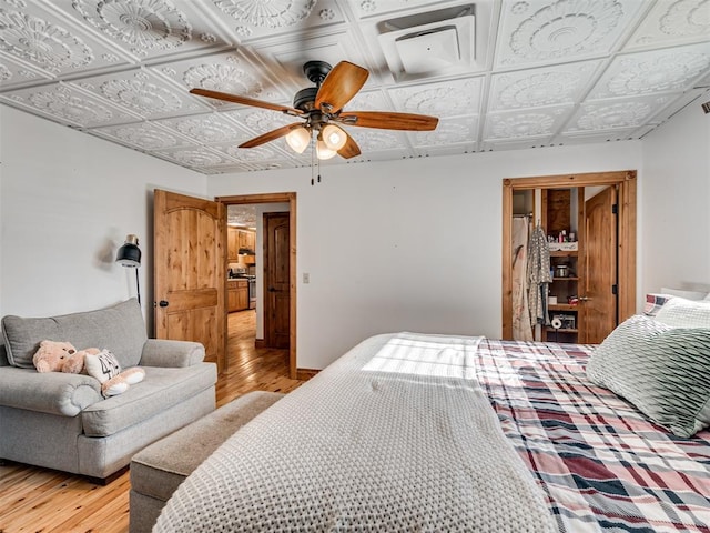 bedroom with light hardwood / wood-style flooring and ceiling fan