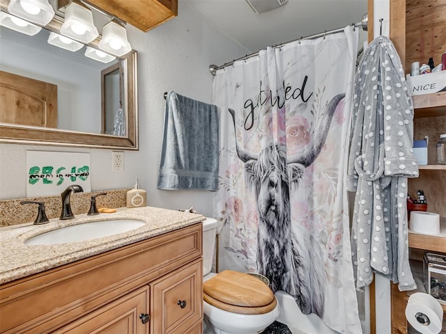 bathroom featuring vanity and toilet