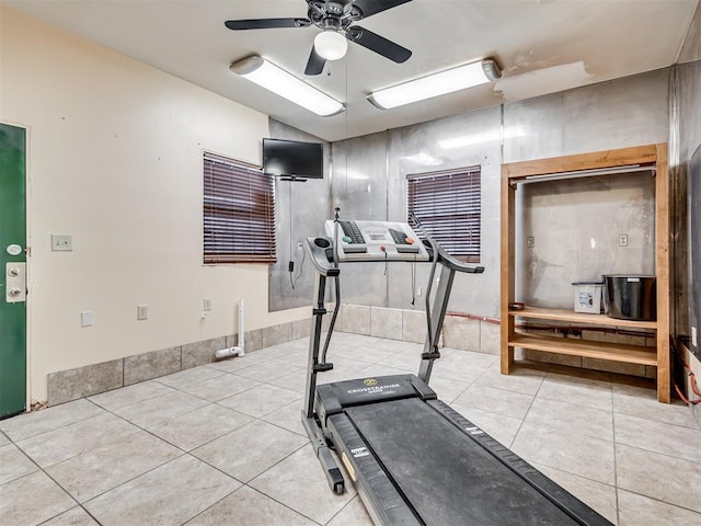 workout area featuring ceiling fan and light tile patterned floors