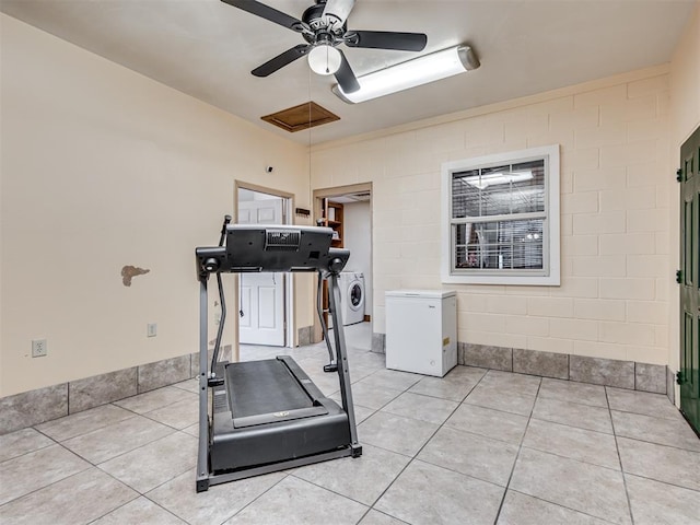 workout room with light tile patterned floors, washer / clothes dryer, and ceiling fan