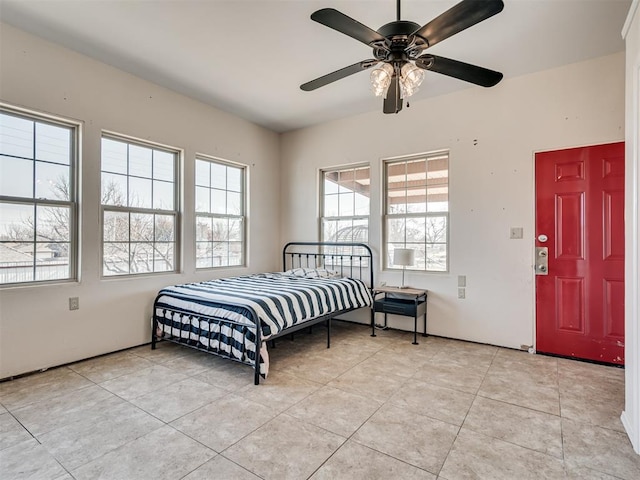 tiled bedroom with ceiling fan