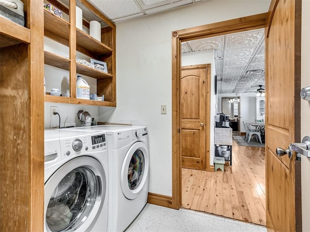 laundry area featuring ceiling fan, light wood-type flooring, and separate washer and dryer