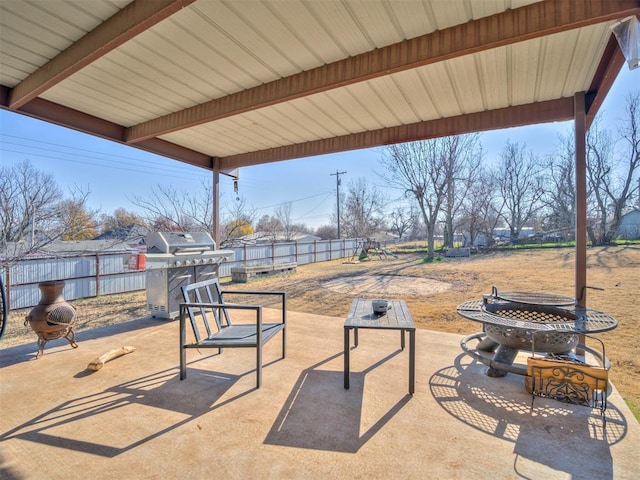 view of patio featuring an outdoor fire pit and a grill