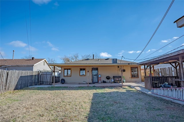 rear view of property featuring a patio area and a yard