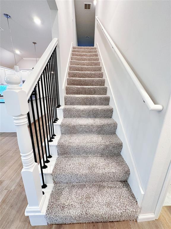 stairway featuring wood-type flooring