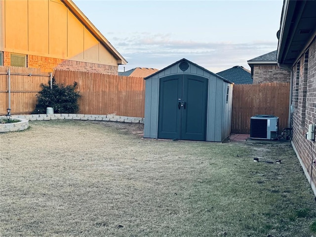 view of shed featuring central air condition unit and a fenced backyard