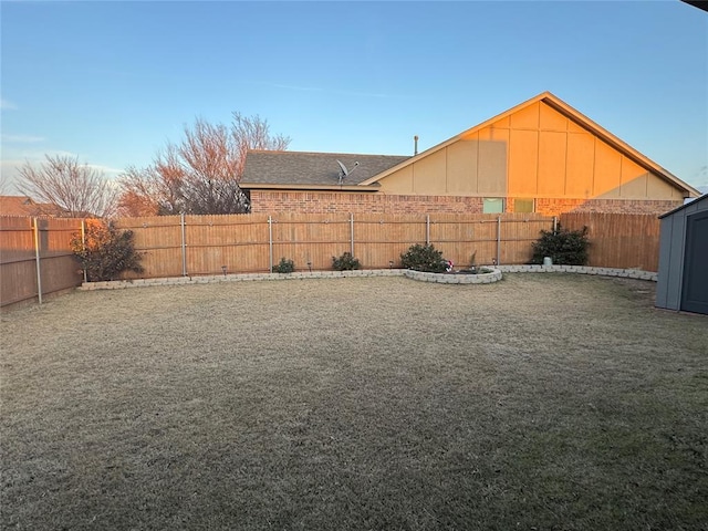 view of yard with an outbuilding and a fenced backyard