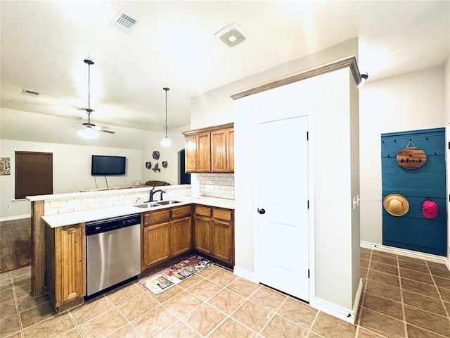 kitchen with visible vents, brown cabinets, a sink, stainless steel dishwasher, and a peninsula