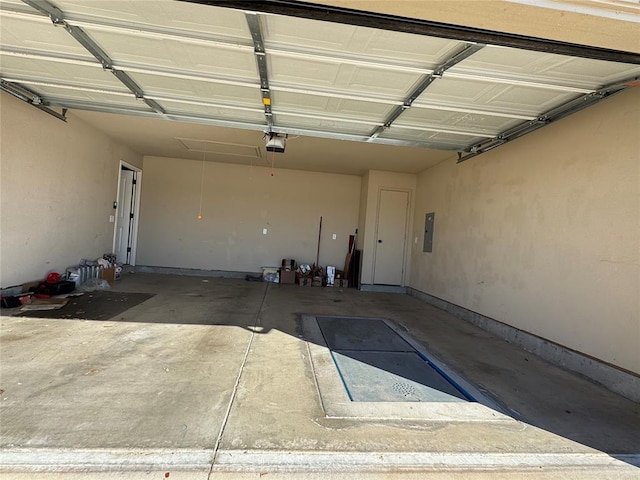 garage with electric panel and a garage door opener