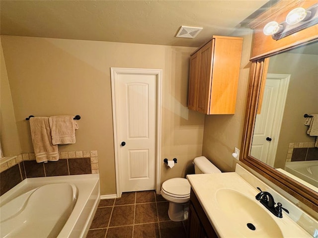 bathroom featuring vanity, visible vents, a garden tub, toilet, and tile patterned floors