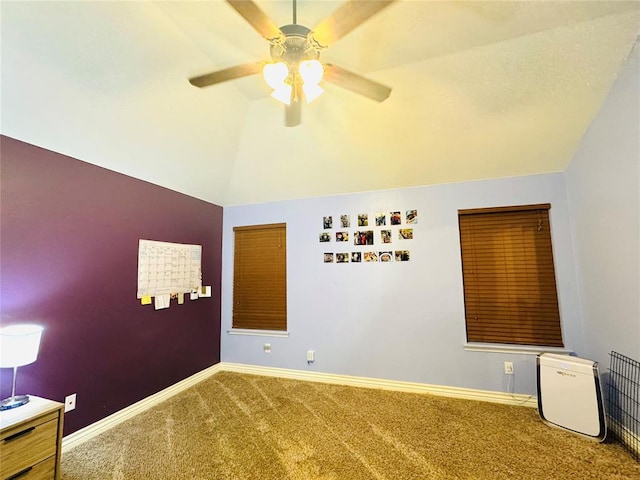 spare room featuring ceiling fan, baseboards, carpet, and vaulted ceiling