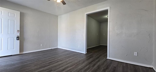 spare room with ceiling fan and dark wood-type flooring