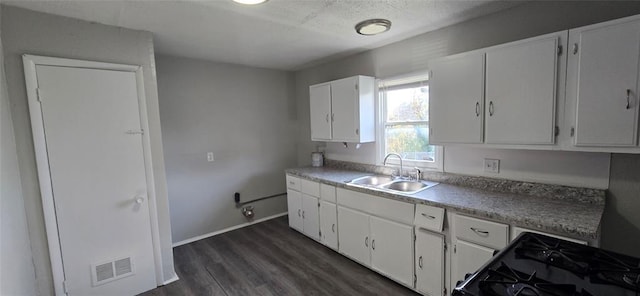 kitchen with white cabinetry, dark hardwood / wood-style flooring, black range with gas cooktop, a textured ceiling, and sink