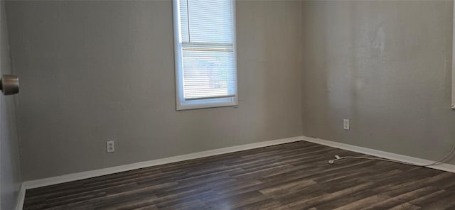 unfurnished room featuring dark wood-type flooring