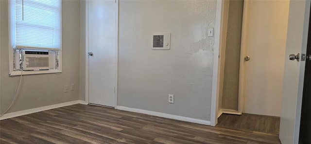 empty room with dark wood-type flooring and cooling unit