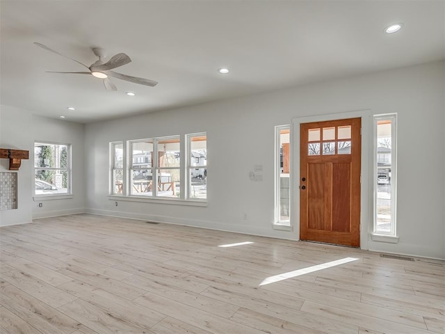 foyer entrance with light wood-type flooring and ceiling fan