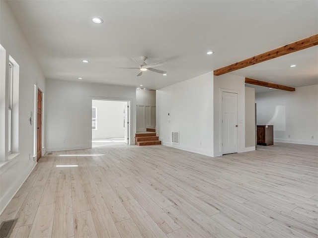 unfurnished living room with ceiling fan, beam ceiling, and light hardwood / wood-style flooring