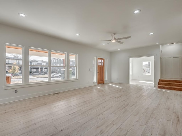 unfurnished living room featuring light hardwood / wood-style flooring and ceiling fan