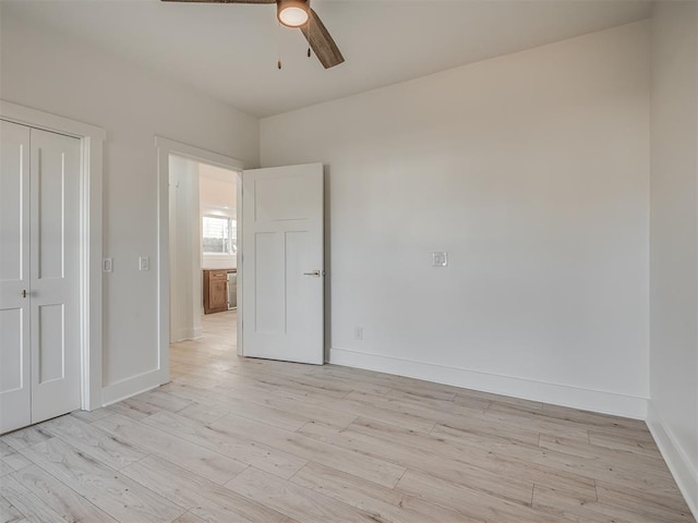 spare room with ceiling fan and light wood-type flooring