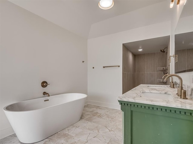 bathroom with a bathtub, vanity, and vaulted ceiling