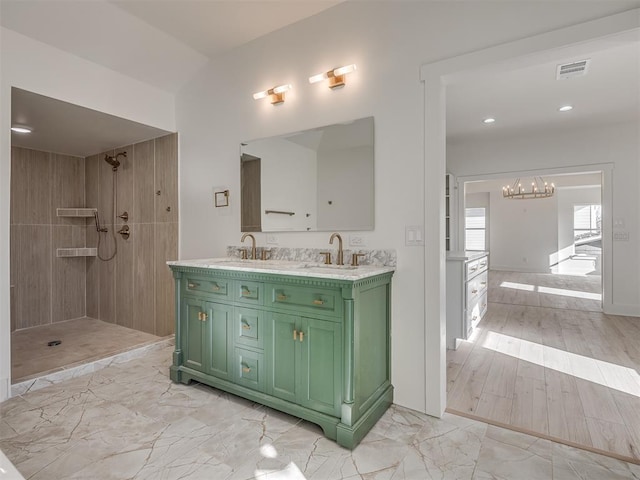 bathroom with hardwood / wood-style floors, vanity, and a shower