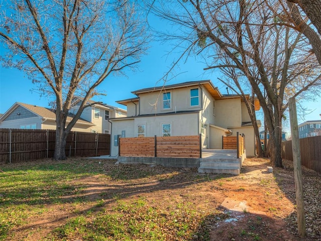 rear view of property with a garage