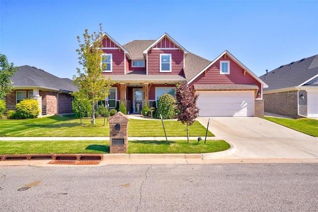 craftsman house featuring a garage and a front lawn