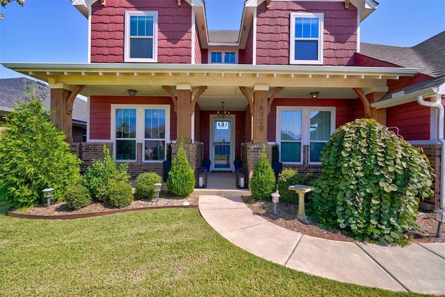 craftsman-style house featuring a front lawn and covered porch