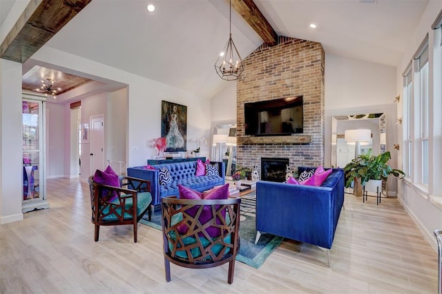 living room with vaulted ceiling with beams, a fireplace, light hardwood / wood-style floors, and an inviting chandelier