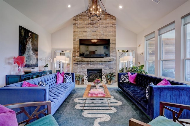 living room with a notable chandelier, a fireplace, and vaulted ceiling