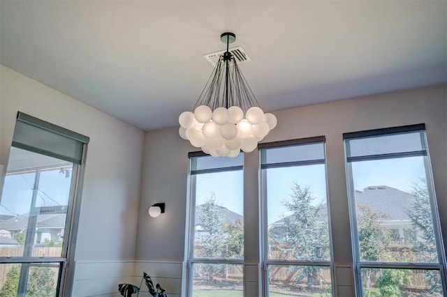 details with a mountain view and a chandelier