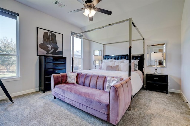 carpeted bedroom with ceiling fan and vaulted ceiling