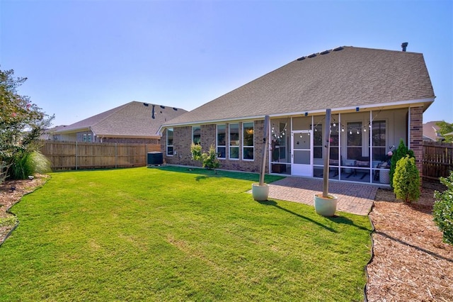 back of house with a lawn