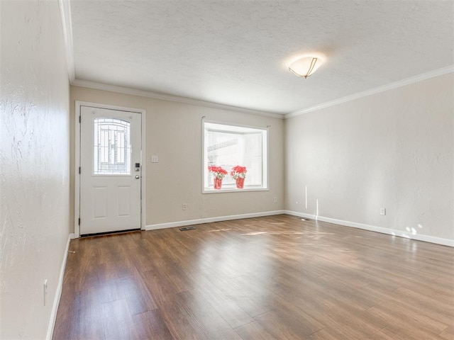 entryway with hardwood / wood-style flooring, crown molding, and a textured ceiling