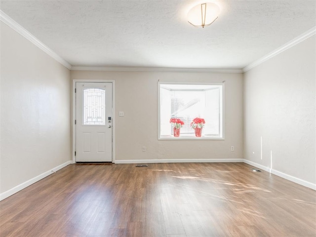 unfurnished room featuring crown molding and wood-type flooring